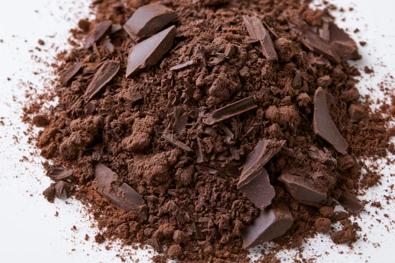 Scattered dark chocolate shavings and broken chunks on surface