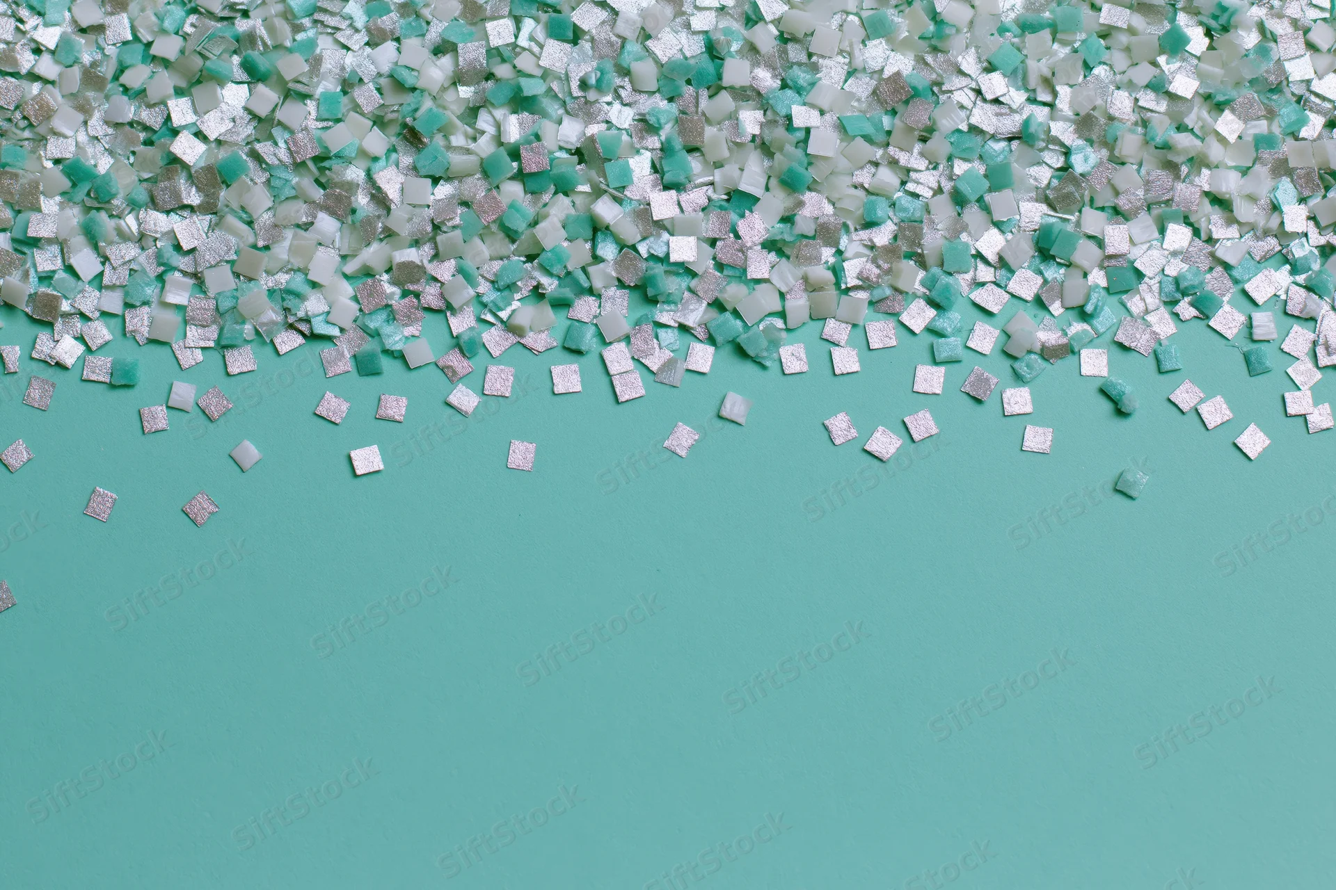 Square confetti pieces scattered densely at top on teal background with copyspace below