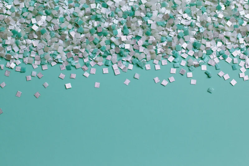 Small square confetti pieces scattered and falling at the top