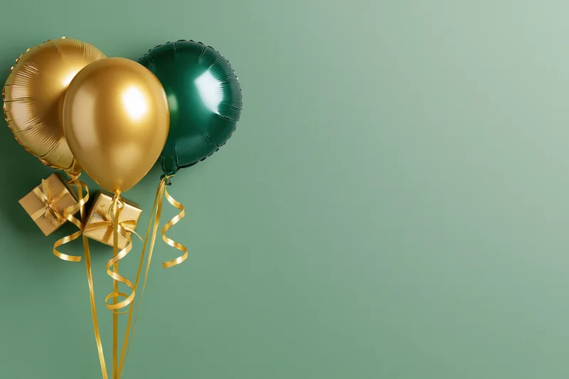 Three metallic balloons two gold and one deep green clustered with gift boxes and ribbons on a green background