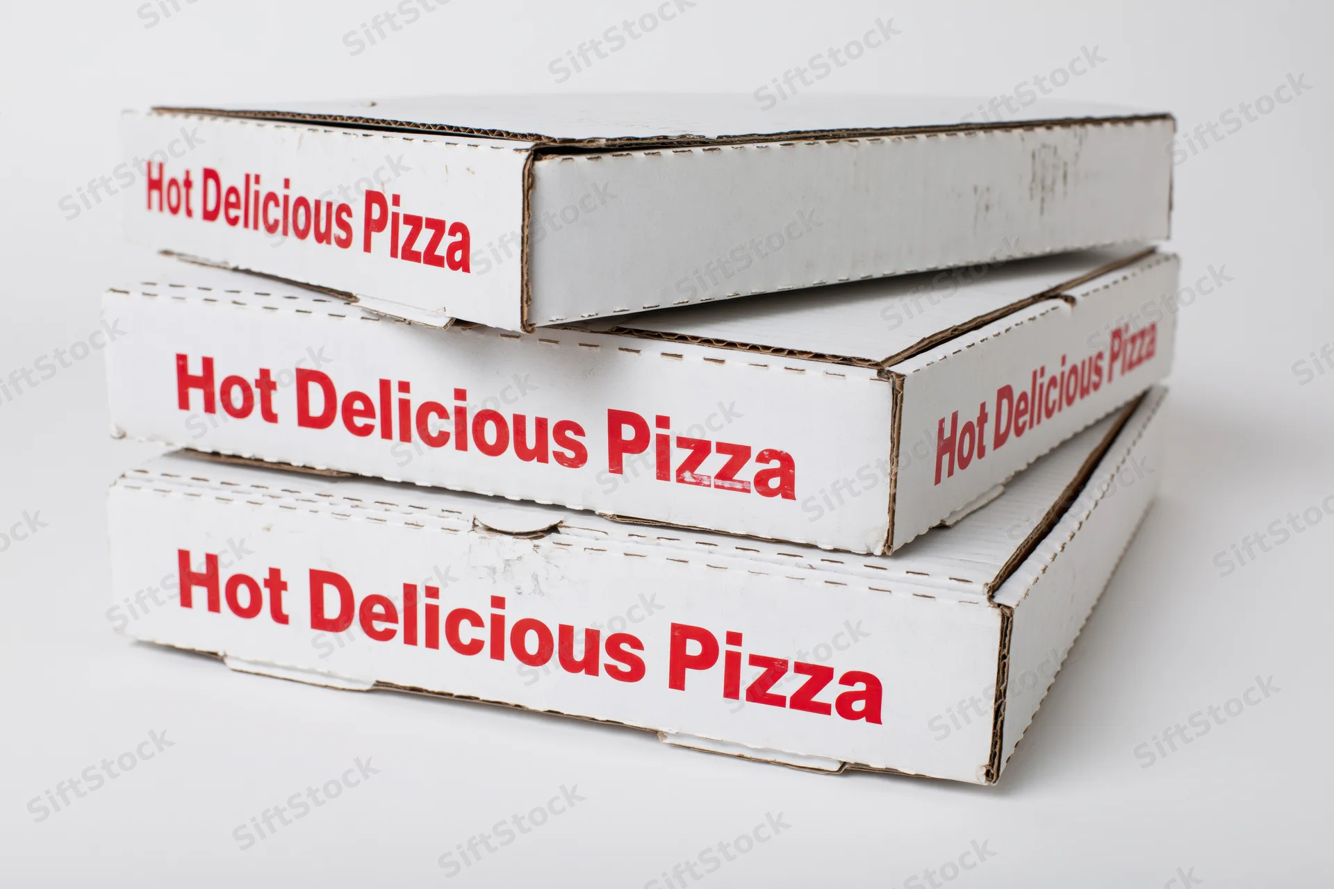Three stacked white cardboard pizza delivery boxes with red text on a plain white background