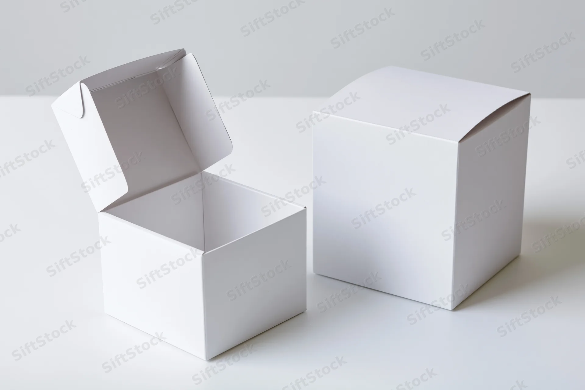 Two plain white cardboard flip-top boxes, one open and one closed, on a white surface