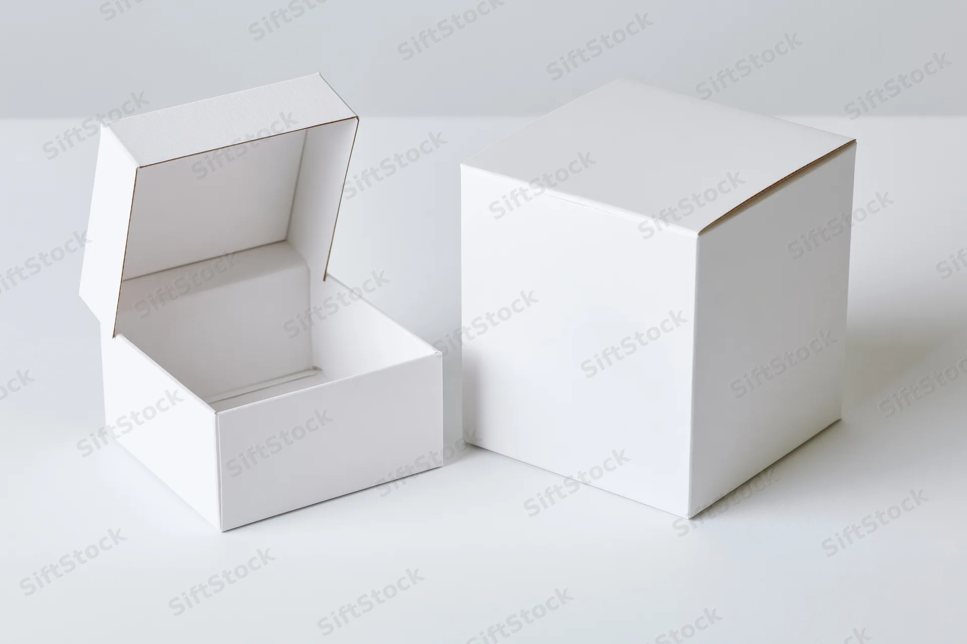 Two plain white cardboard flip-top boxes, one open and one closed, on a white surface