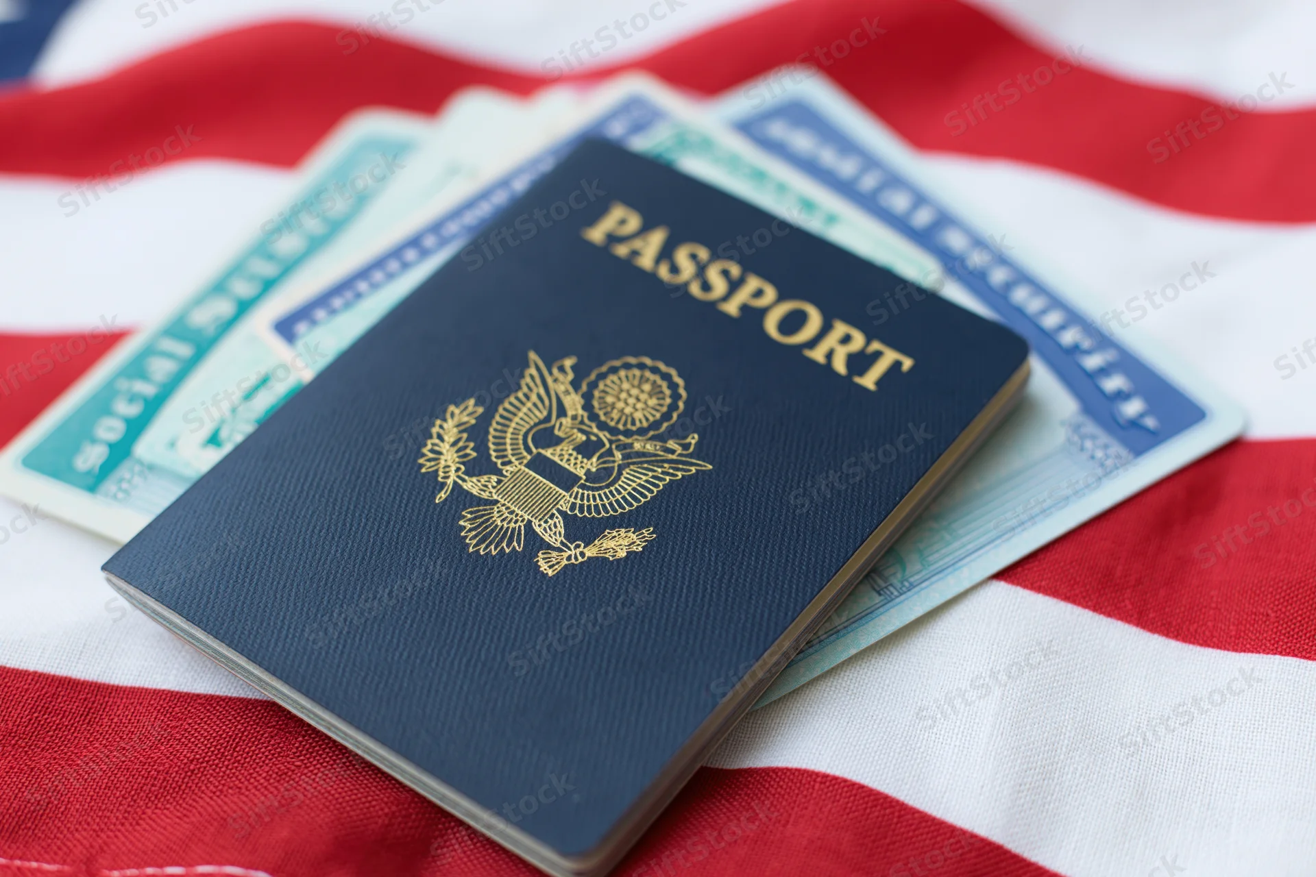 Us passport and social security card fanned on american flag