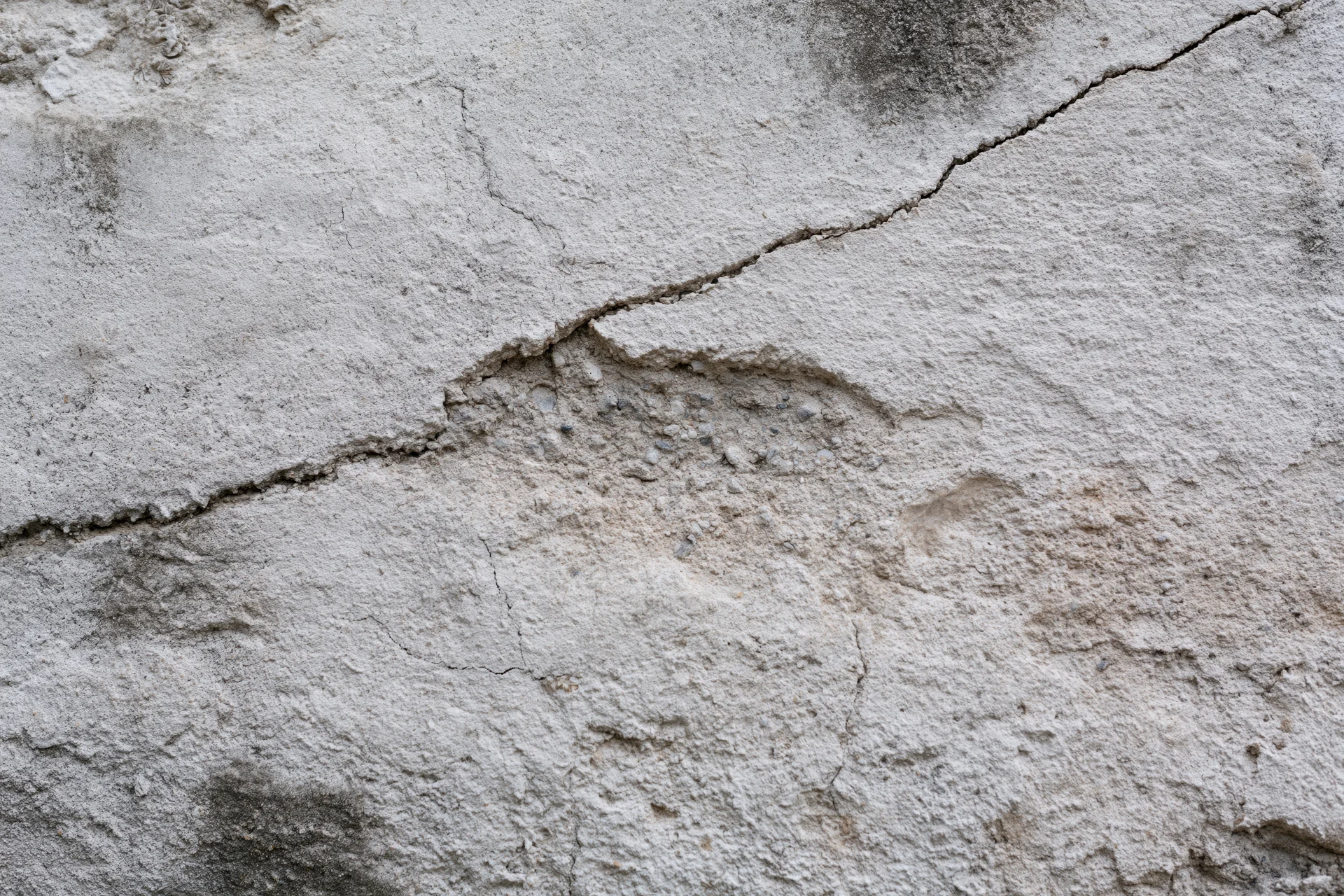 Close-up of cracked and weathered concrete wall surface