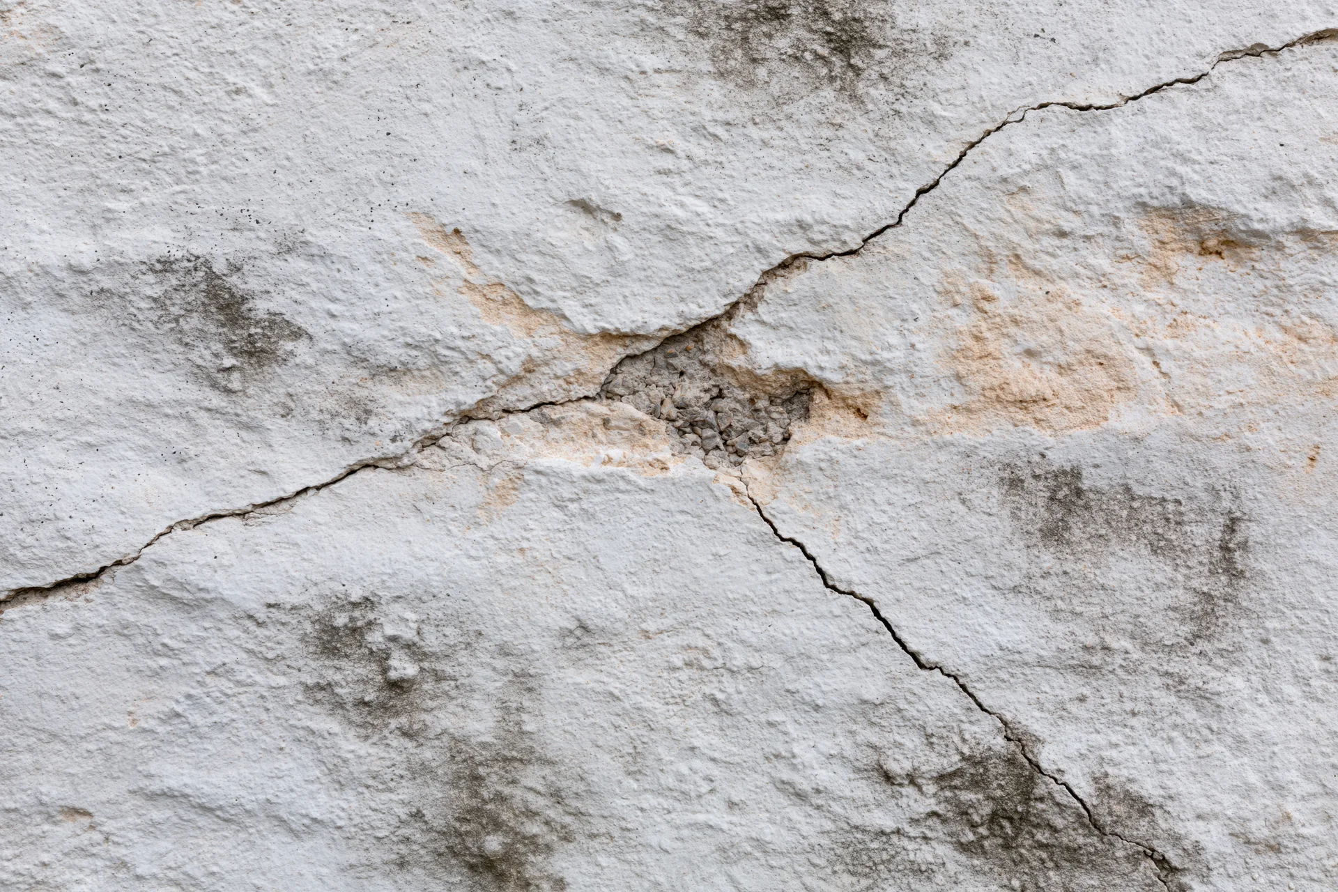 Cracked weathered concrete wall surface filling the frame