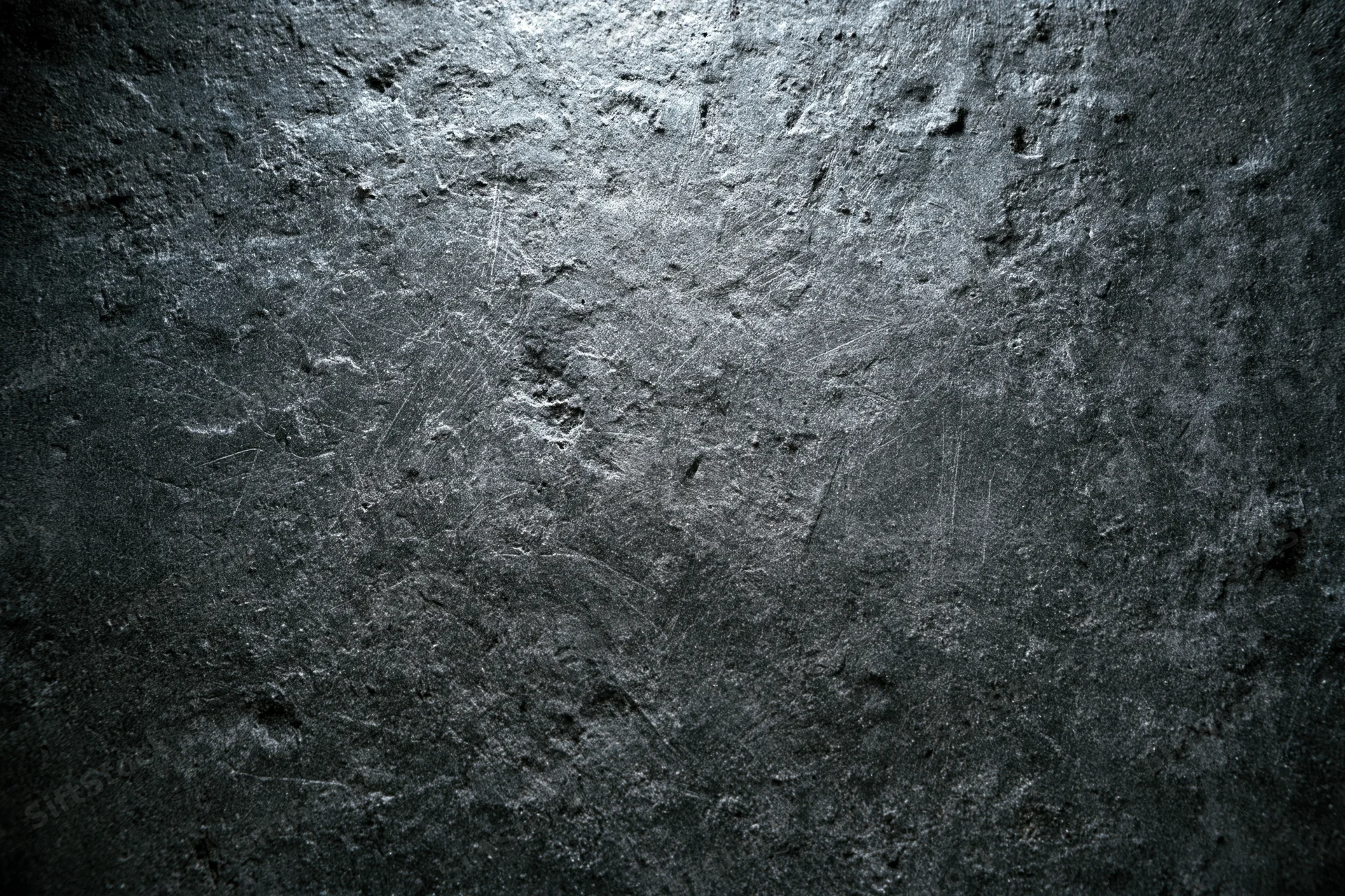 Weathered concrete wall surface filling the frame with rough texture and dark gray tones