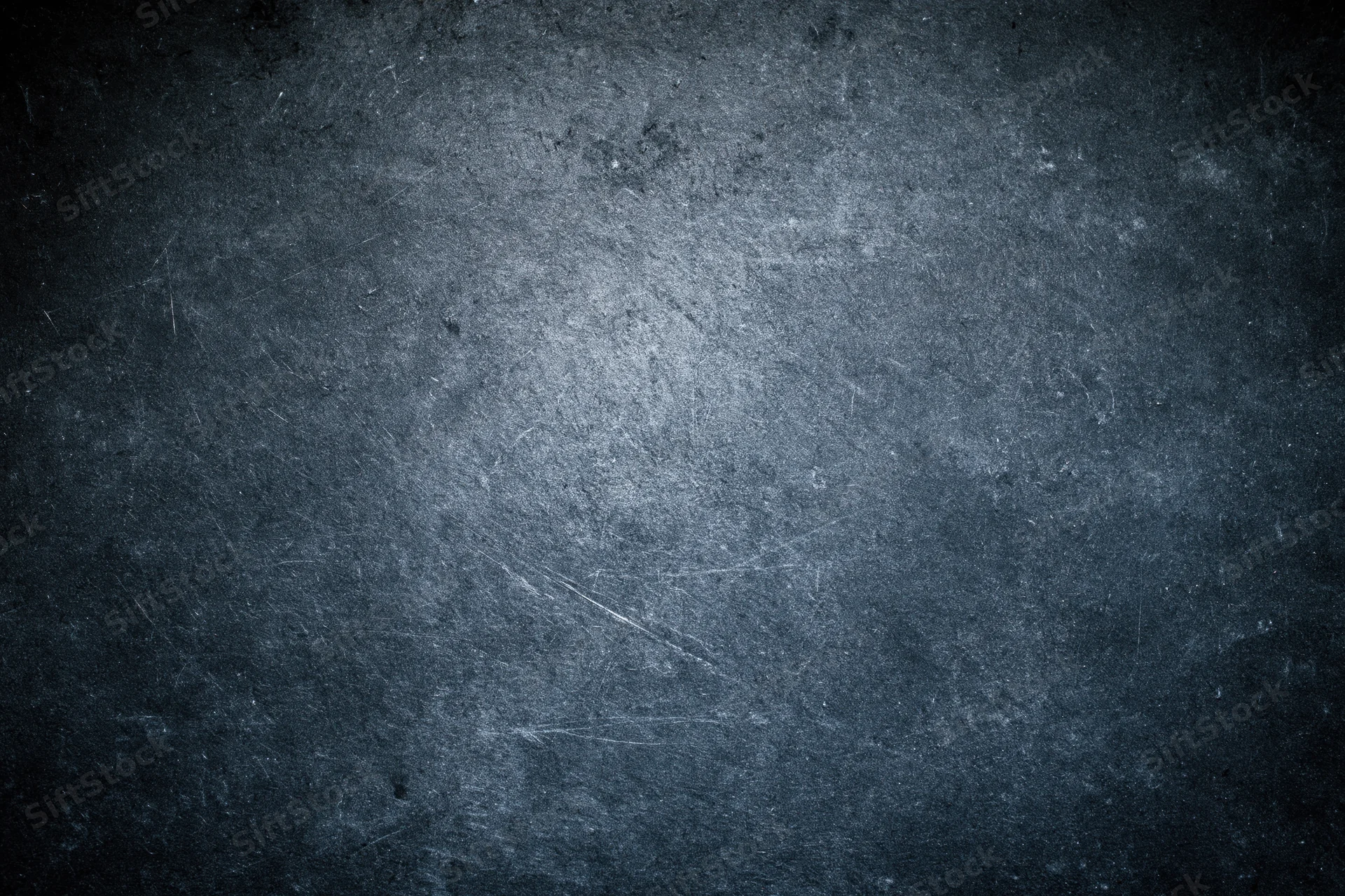 Weathered concrete wall surface filling the frame with visible scratches and dark gray tones