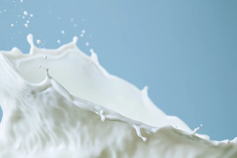 White milk splash mid motion forming a wave with detail