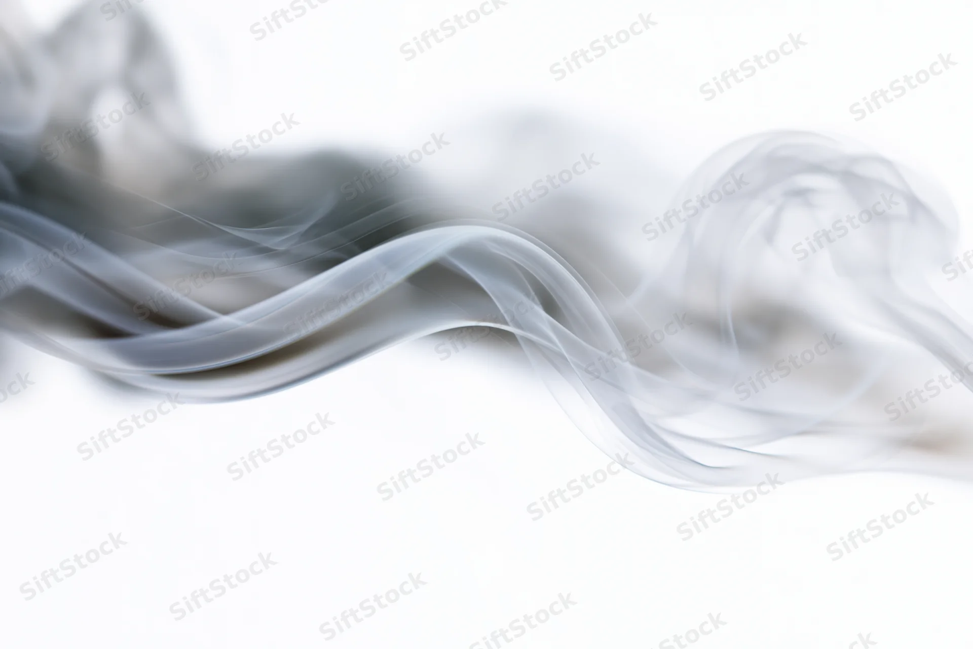 Wispy smoke curling and rising against a pure white background