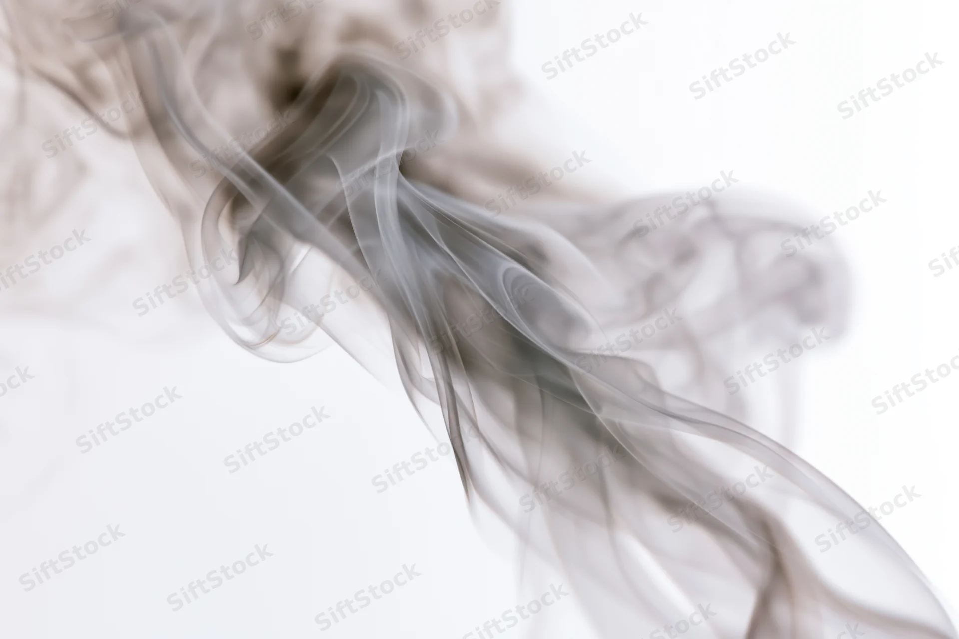 Wispy smoke curling and rising against a pure white background