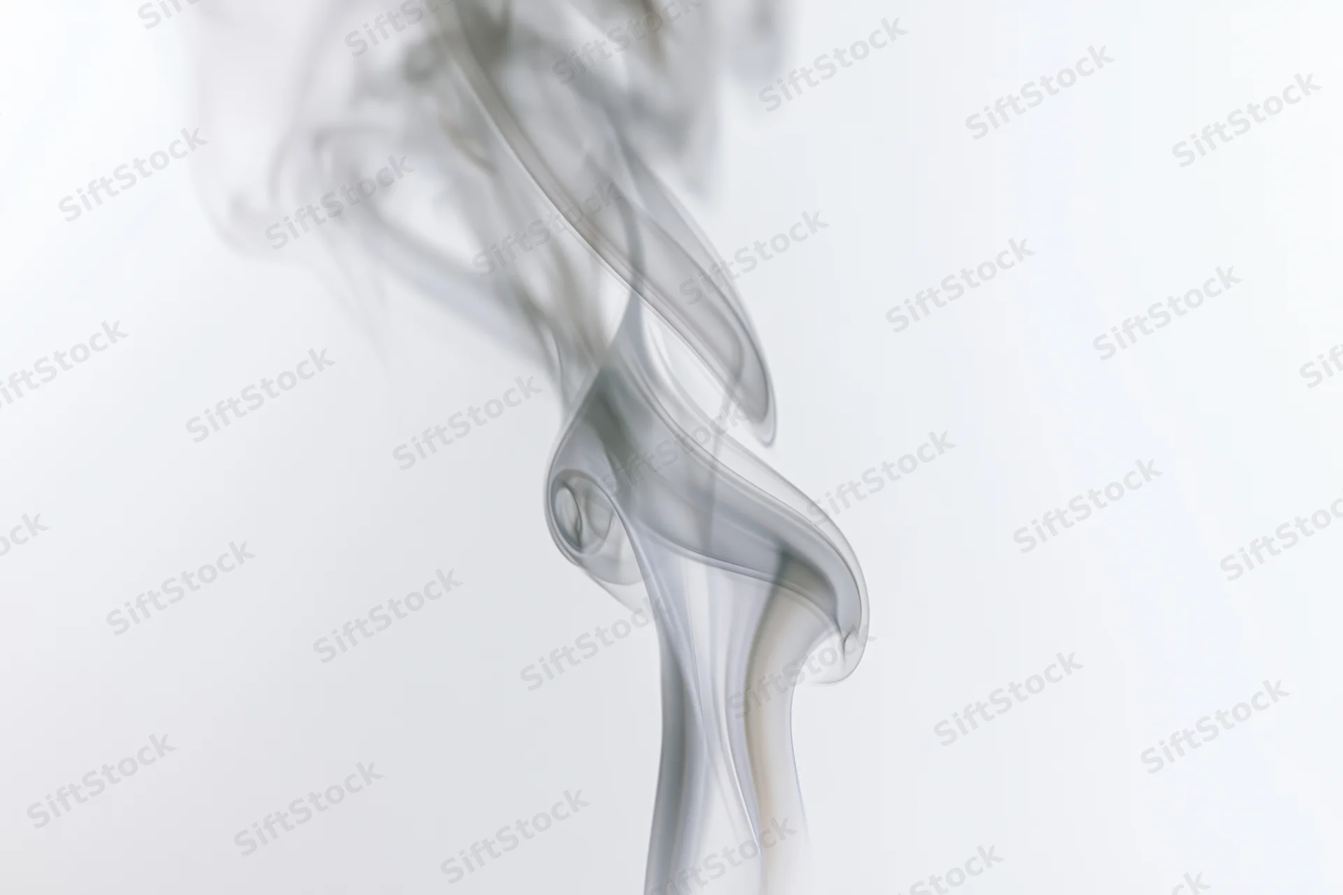 Wispy smoke plume rising and curling against a white background