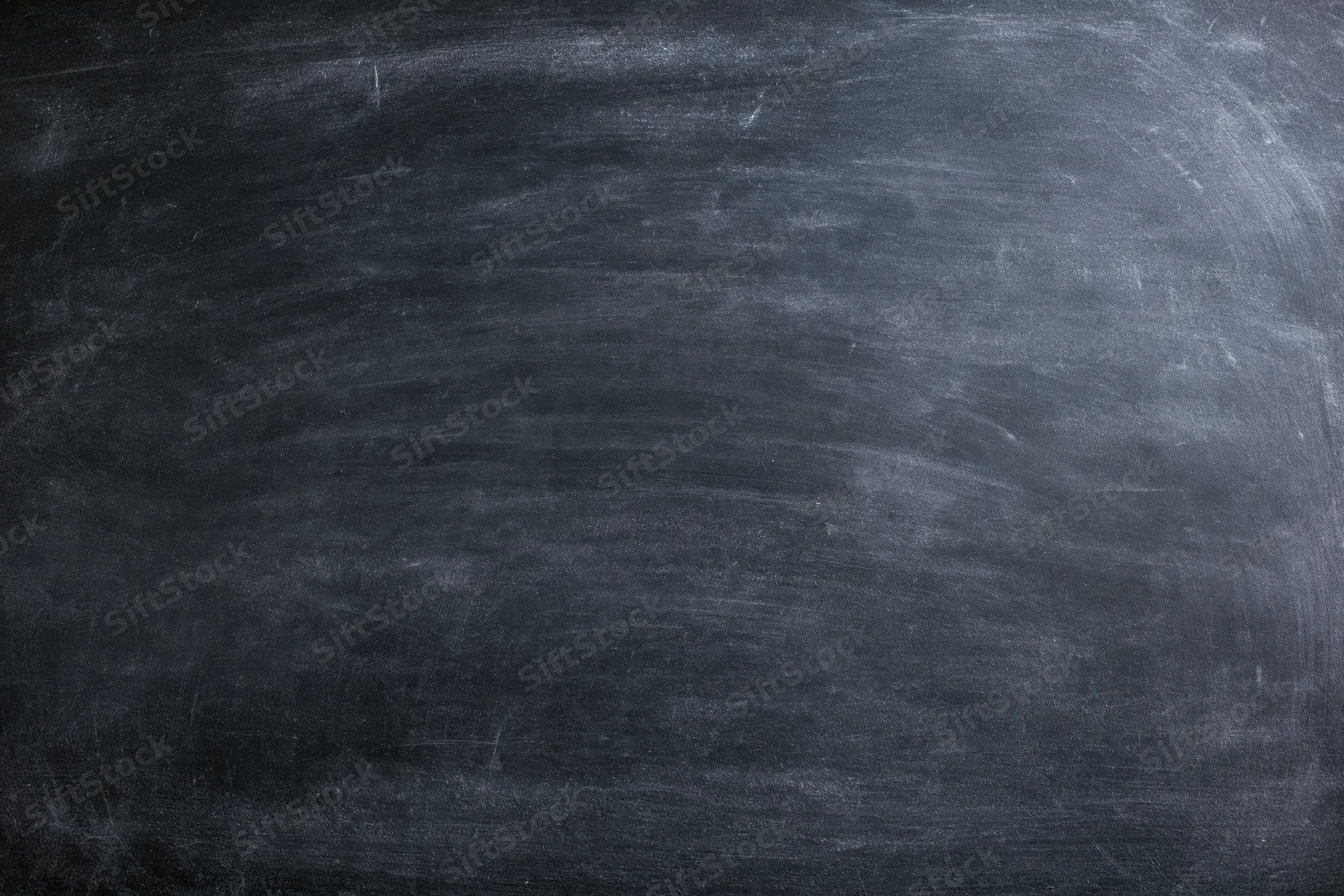Worn chalkboard surface filling the frame with smudged residue and erased marks