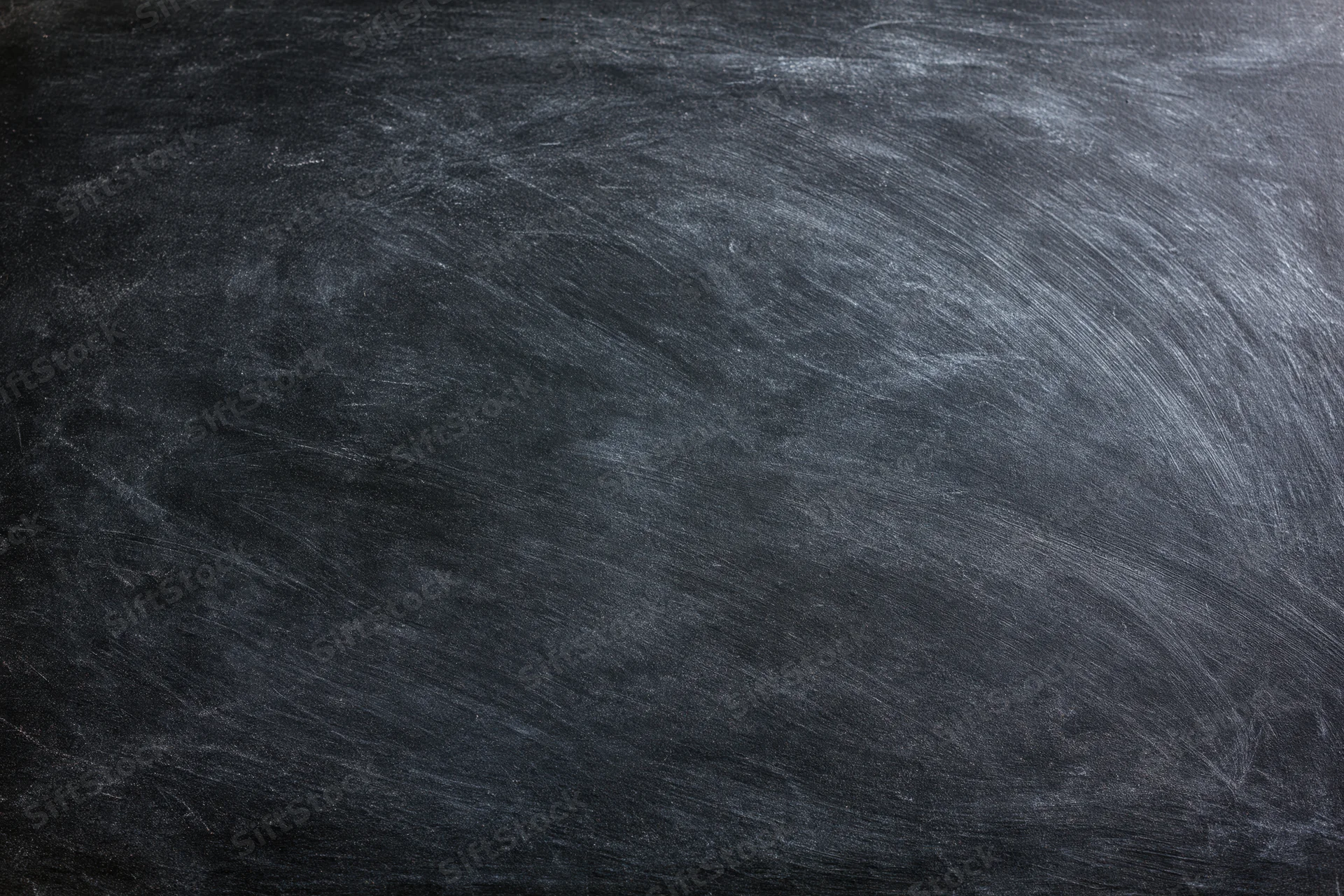 Worn chalkboard surface with smudged chalk residue filling the frame