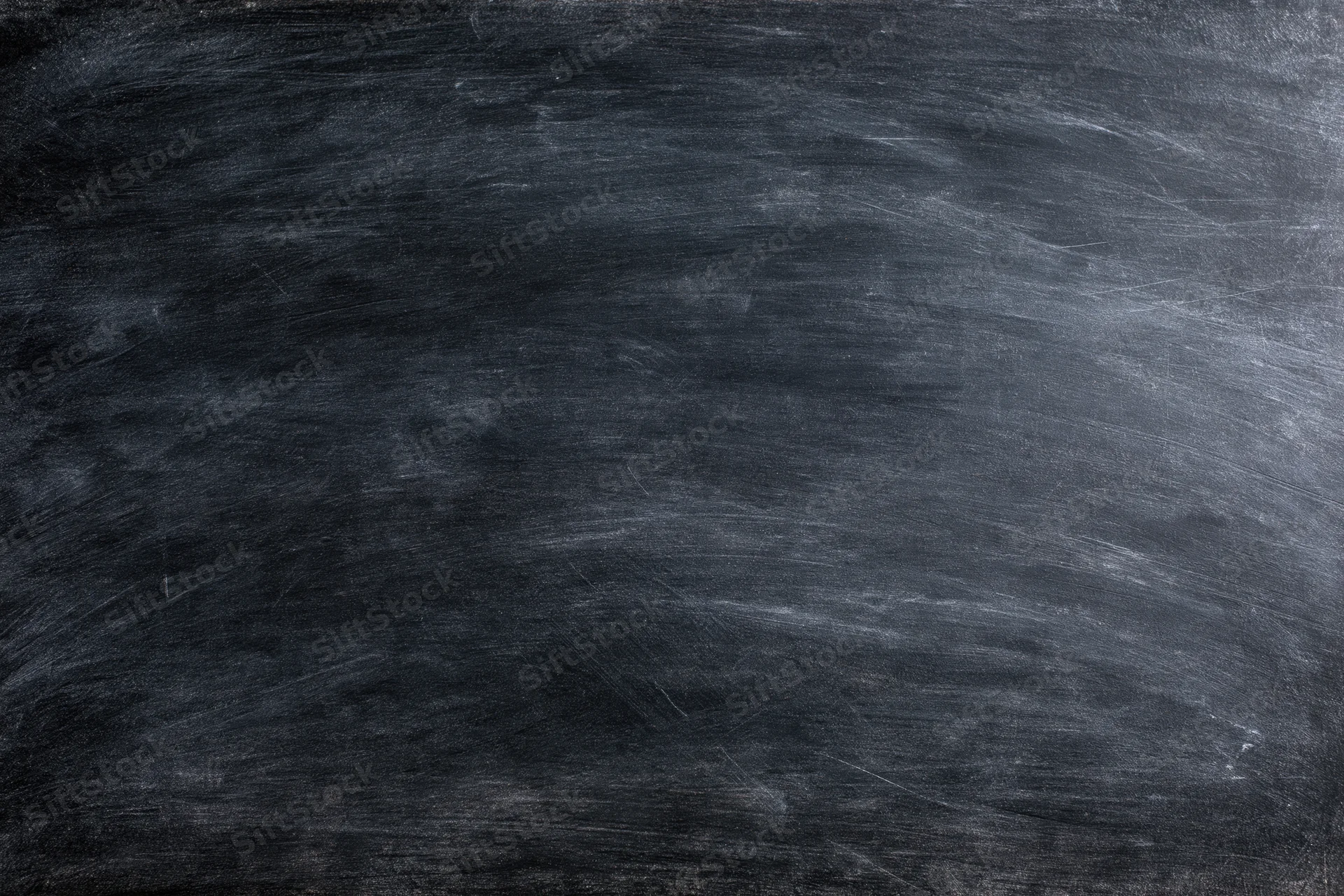 Worn chalkboard surface with smudged chalk residue filling the frame