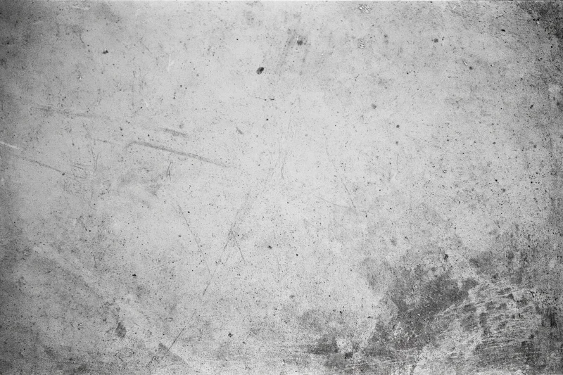 Worn concrete wall surface filling the frame with visible scratches and stains