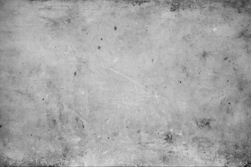 Worn concrete wall surface filling the frame with visible cracks and stains