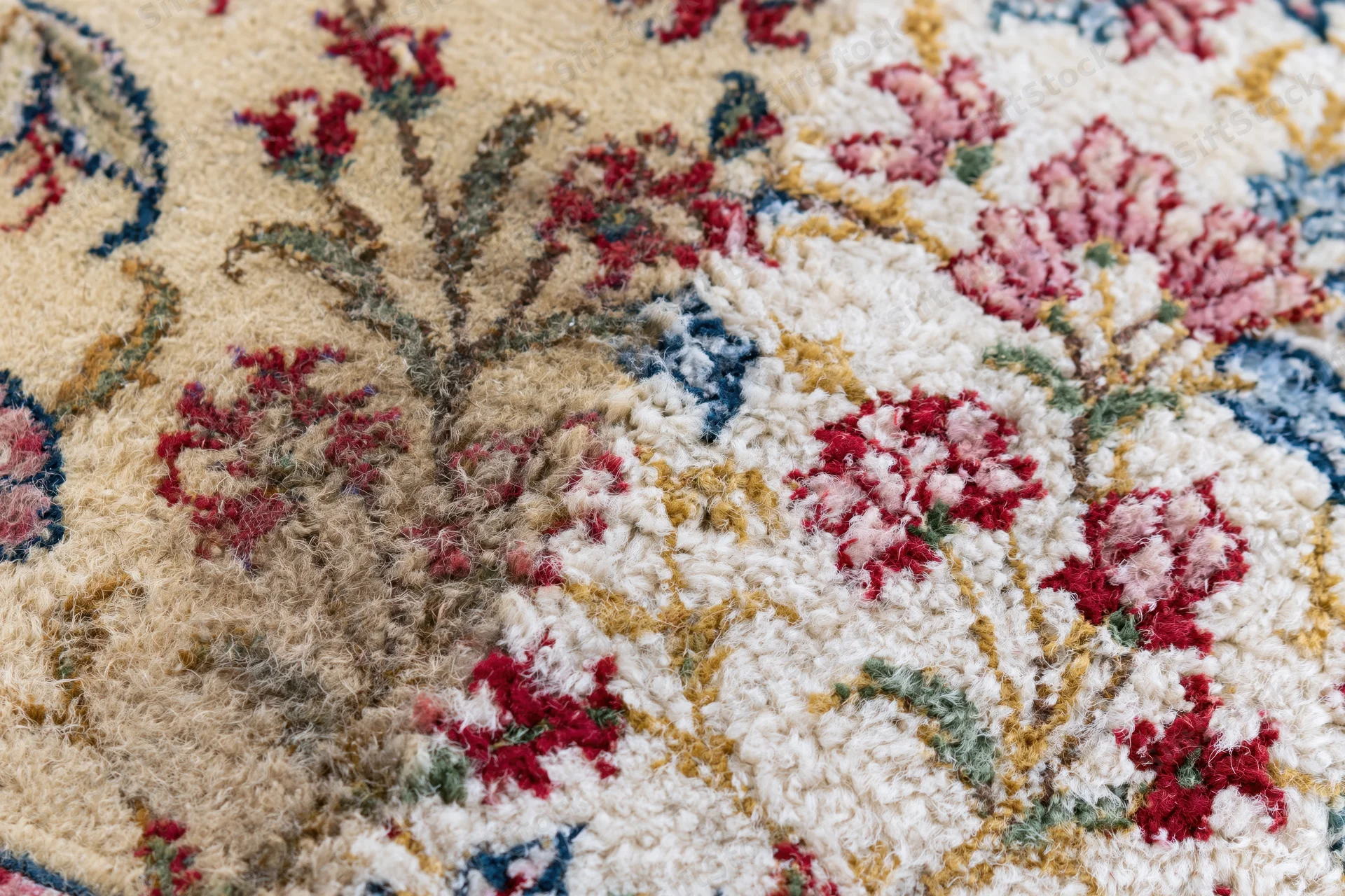 Close-up of a Persian floral rug with intricate wool weave and vintage design