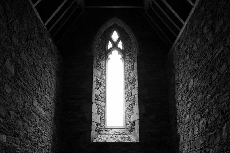 Tall gothic arched window glowing with bright light in stone church interior