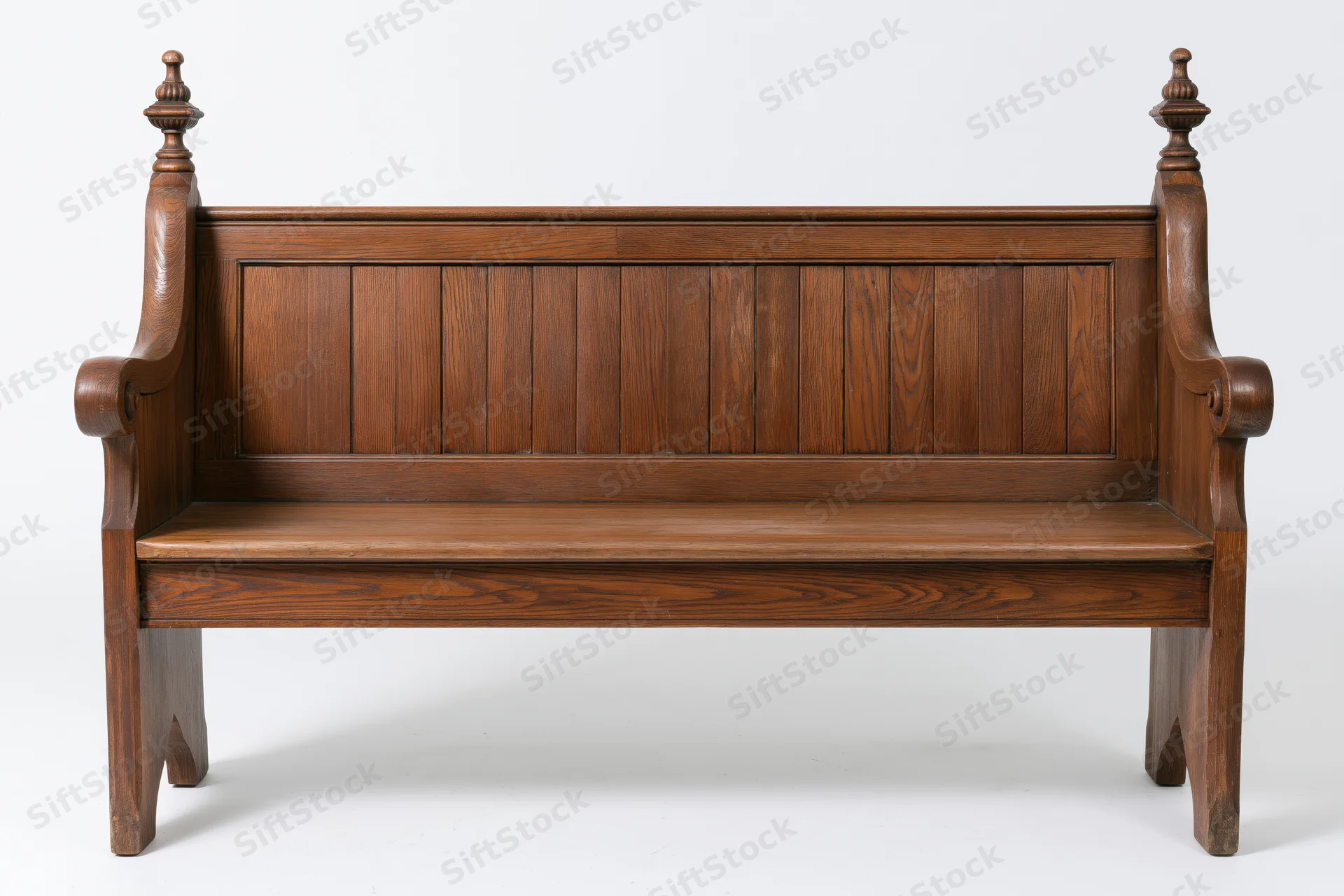 Antique wooden church pew with vertical plank backrest and carved armrests on white background