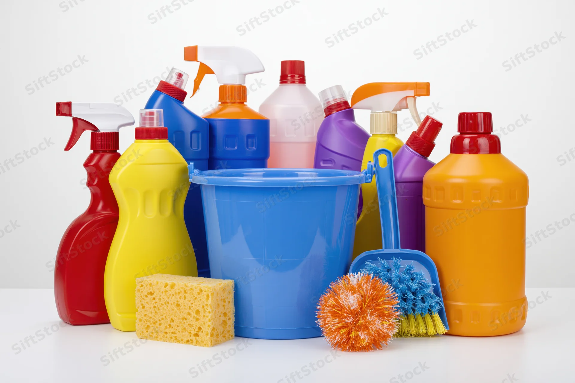Assorted household cleaning supplies arranged on a white surface