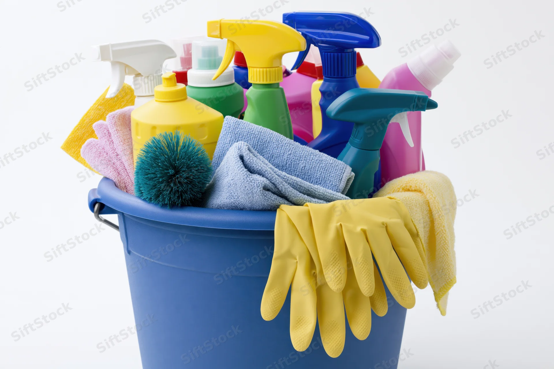 Blue plastic bucket filled with cleaning supplies and gloves on white background