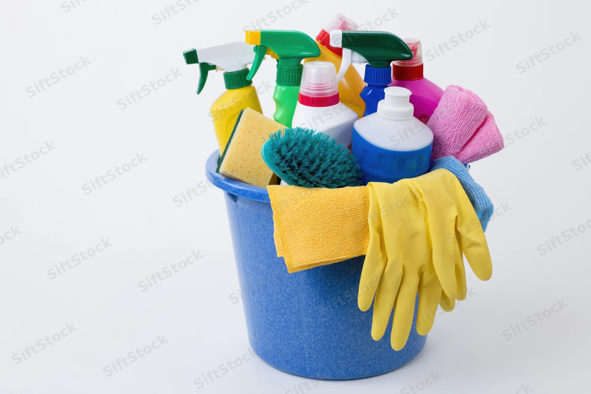 Blue plastic bucket filled with cleaning supplies and tools on white background