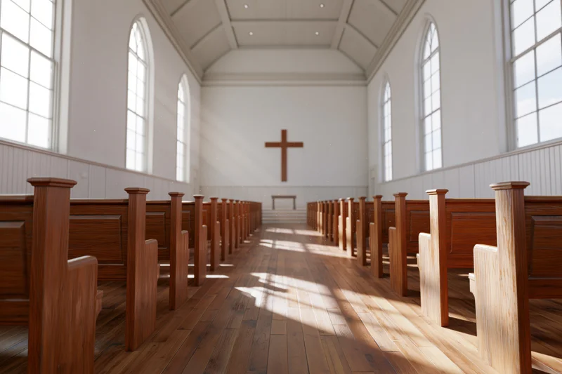 Empty protestant church interior with wooden pews and cross at the front, sunlight streaming through arched windows