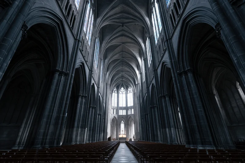 Gothic cathedral nave interior with stone arches and stained glass windows lining the central aisle