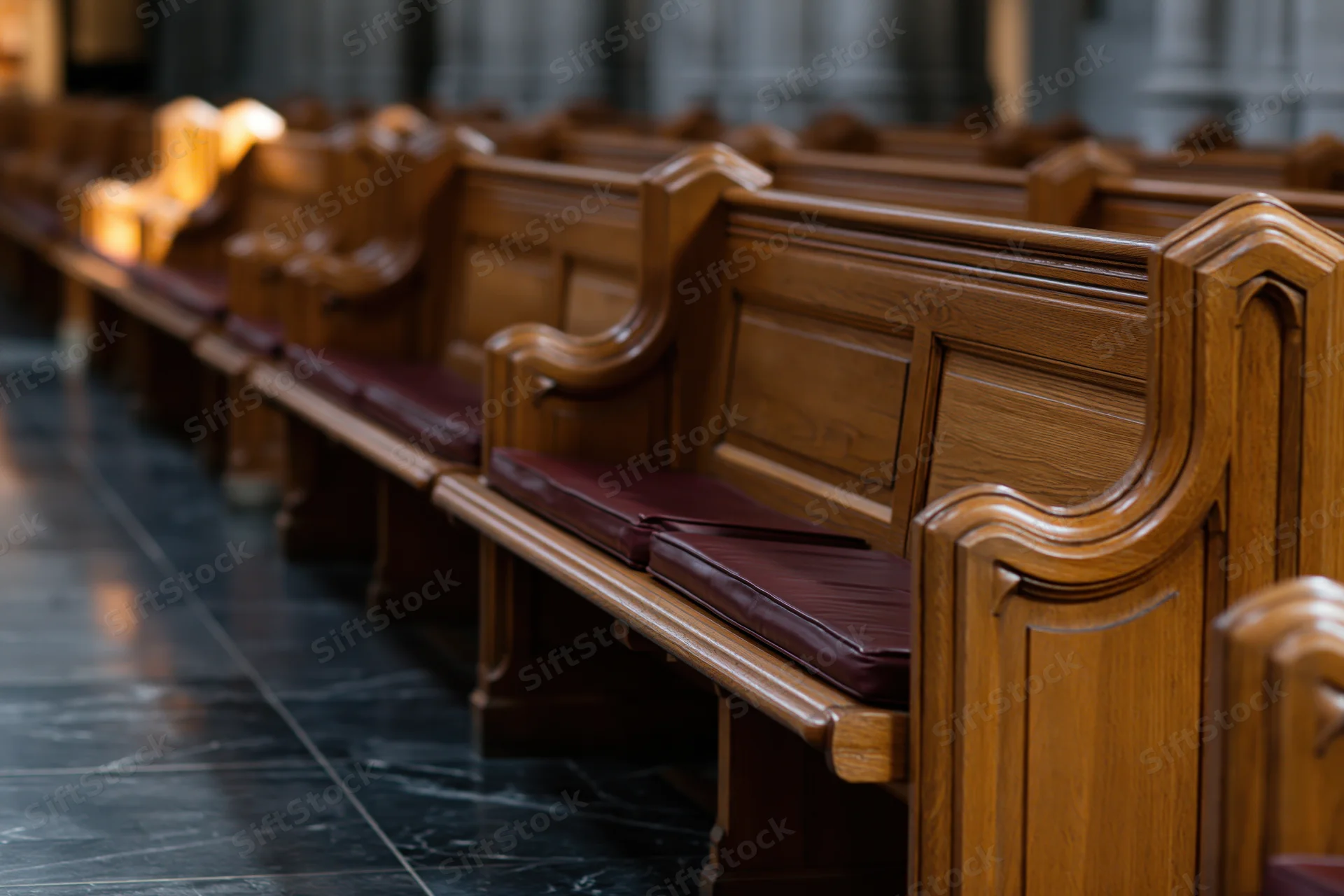 Rows of empty wooden church pews receding into the interior space