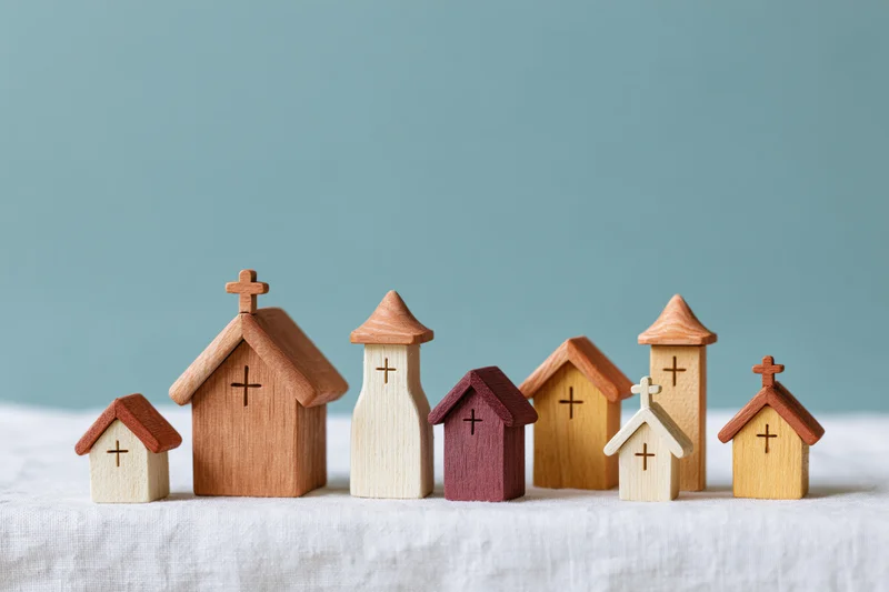 Wooden miniature church figurines arranged in a row on a white surface against a blue background