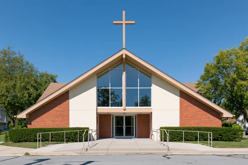 Suburban protestant church exterior with wooden cross above glass entrance and brick facade