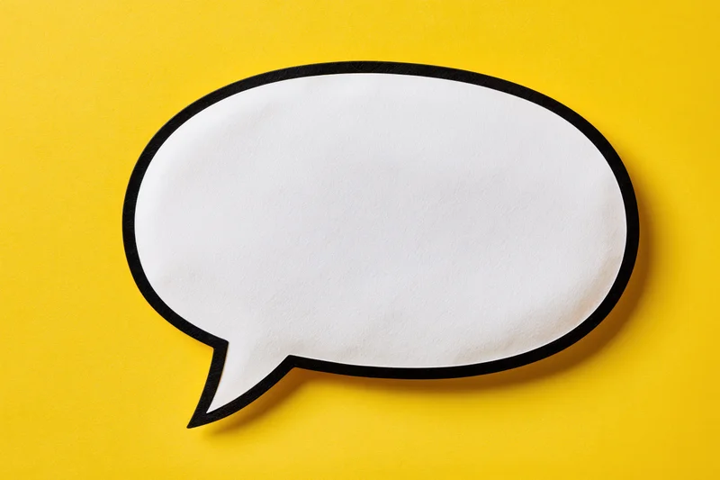 Blank white speech bubble with thick black outline on yellow background