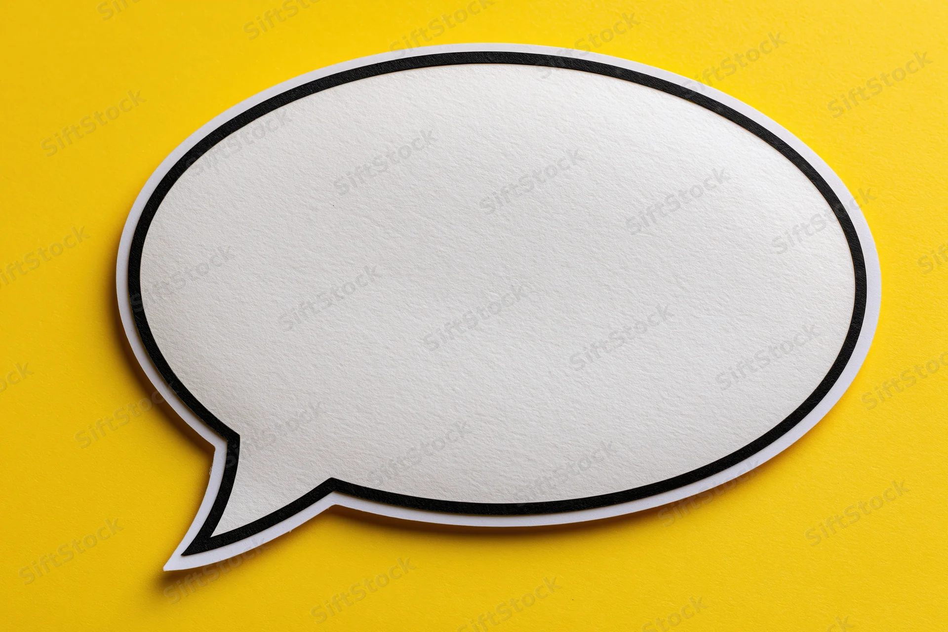 Blank white speech bubble with thick black outline on yellow background