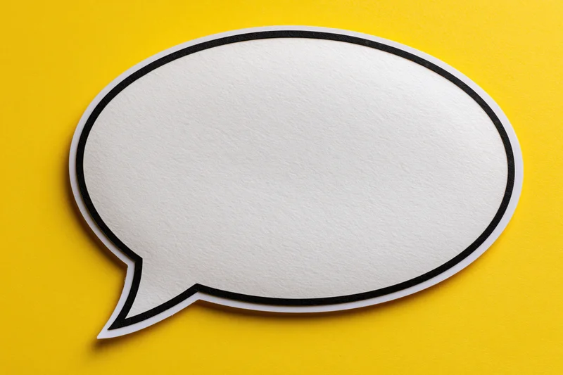 Blank white speech bubble with thick black outline on yellow background