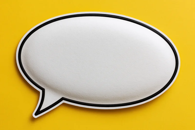 Blank white speech bubble with thick black outline on yellow background