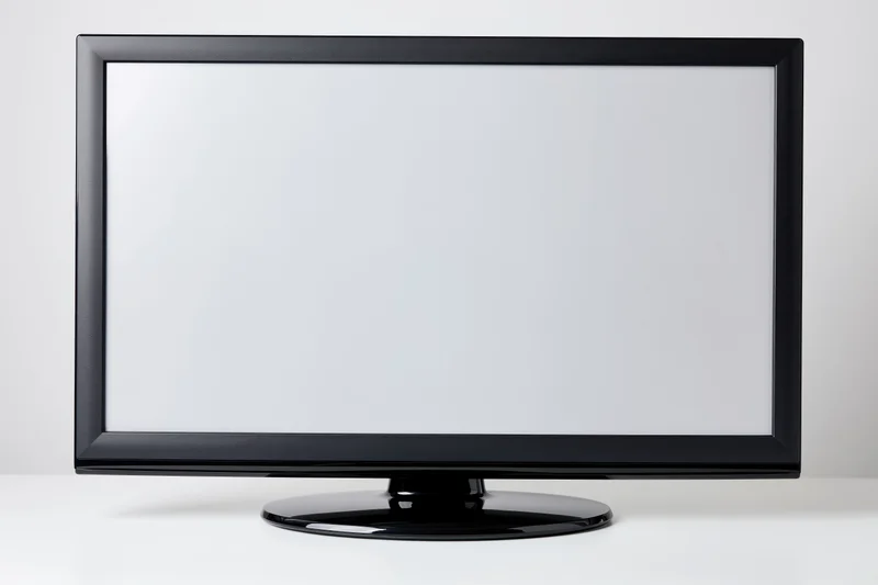 Flat-screen led television with blank white screen on white surface
