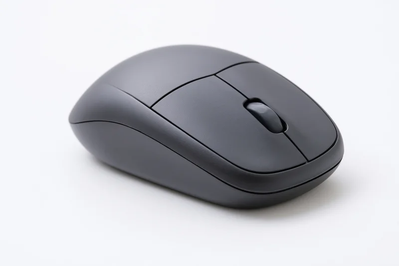 Matte black wireless computer mouse on plain white surface