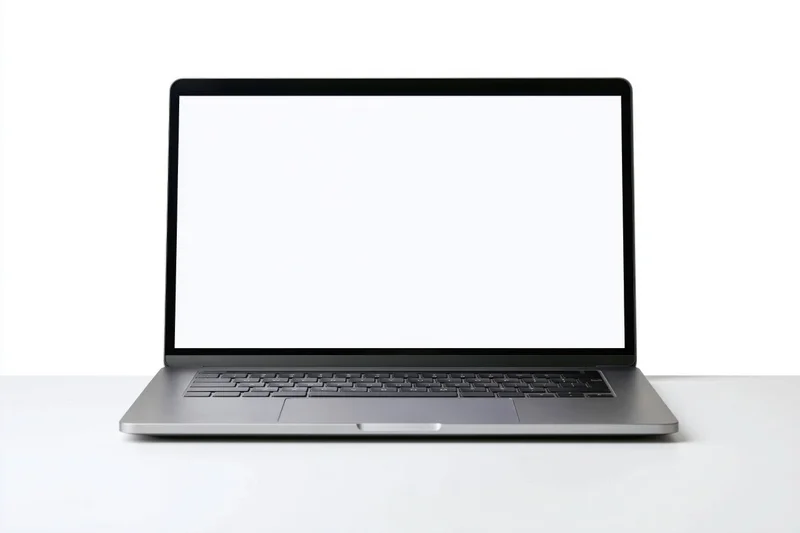 Slim modern laptop with blank white screen open on white surface