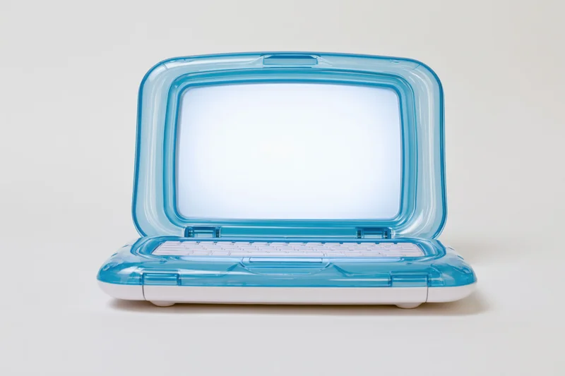 Translucent blue plastic childrens toy laptop open on white surface