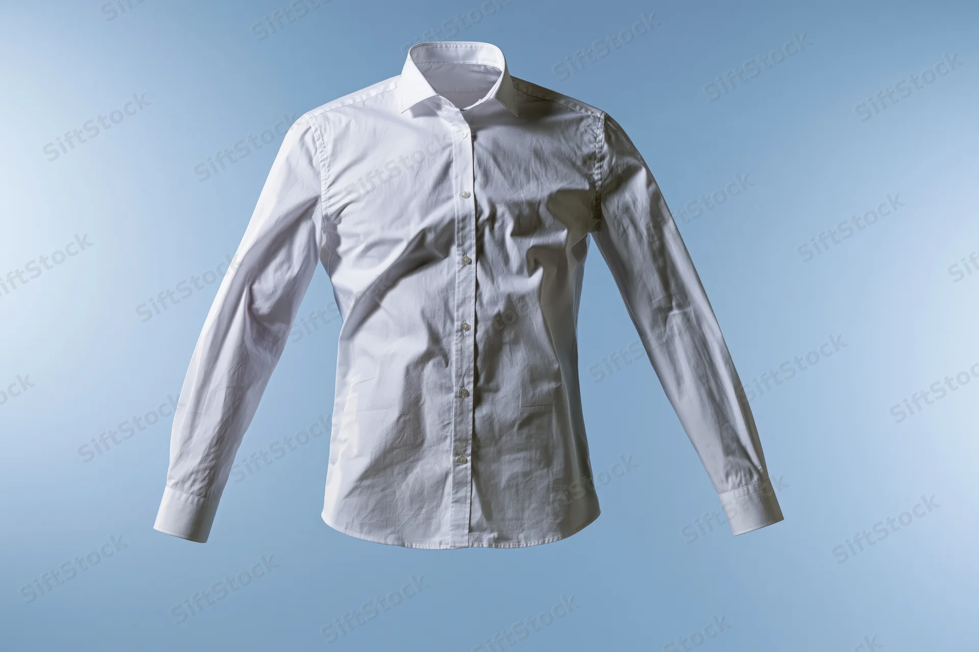 White long-sleeve button-up dress shirt floating mid-air against a light blue background