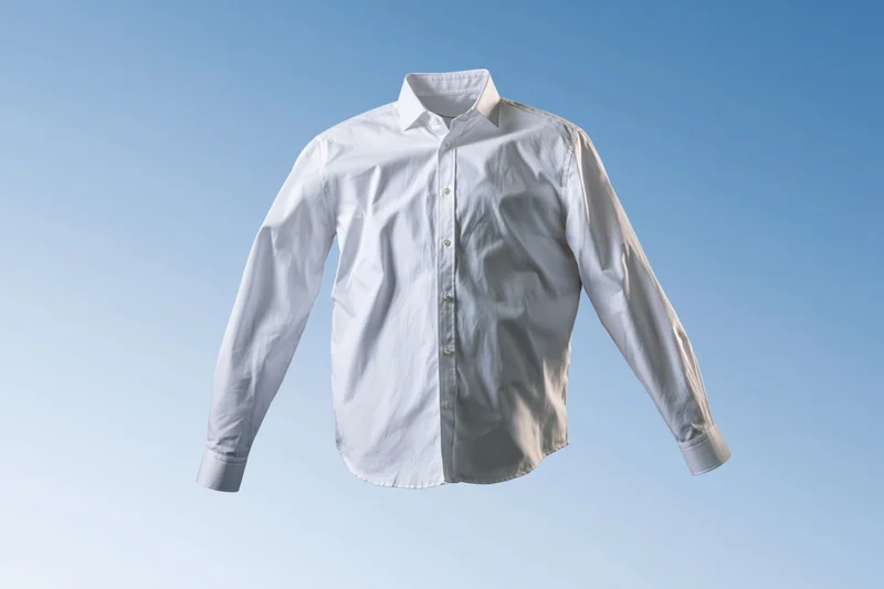 White long-sleeve button-up dress shirt floating mid-air with one half crisp and one half wrinkled against a blue gradient background
