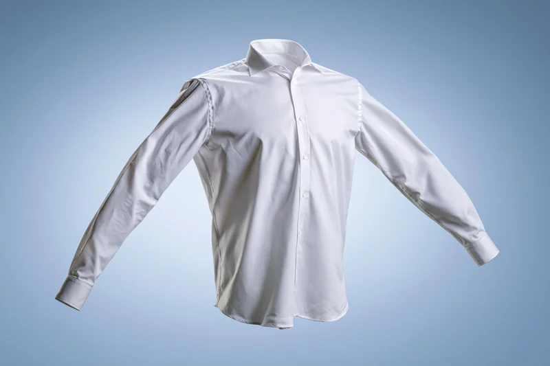 White long-sleeve button-up dress shirt floating mid-air against a light blue gradient background