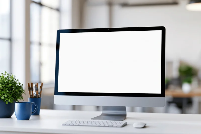 All-in-one desktop computer with blank white screen on office desk