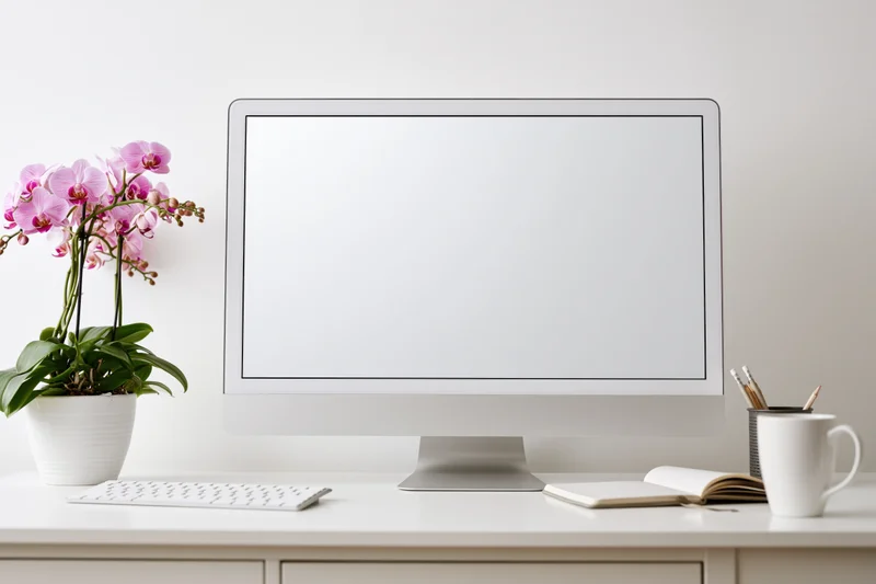 All-in-one desktop computer with blank white screen on a minimalist white desk with orchid, notebook, mug and keyboard