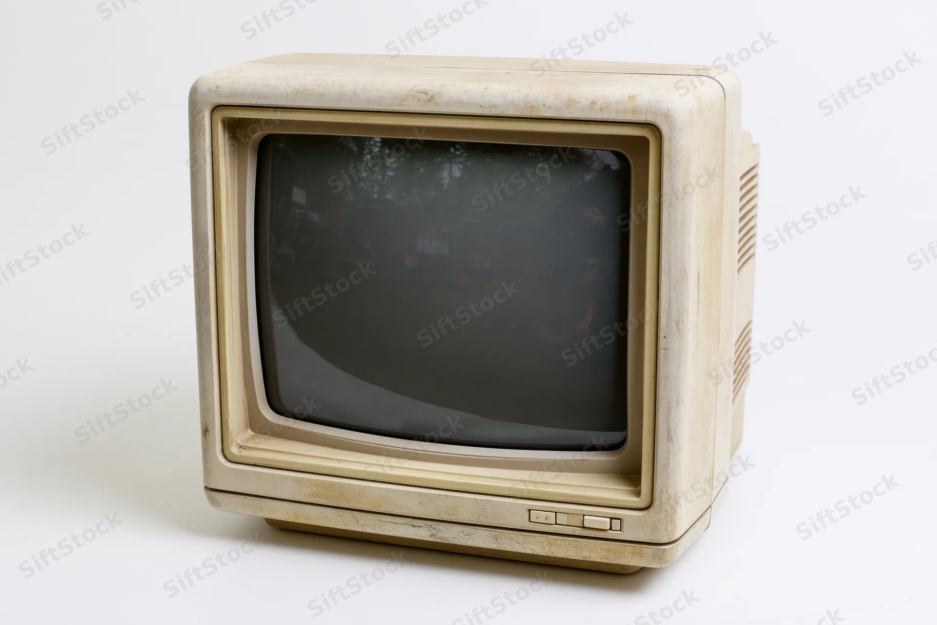Vintage beige crt computer monitor with curved screen and plastic casing on white background