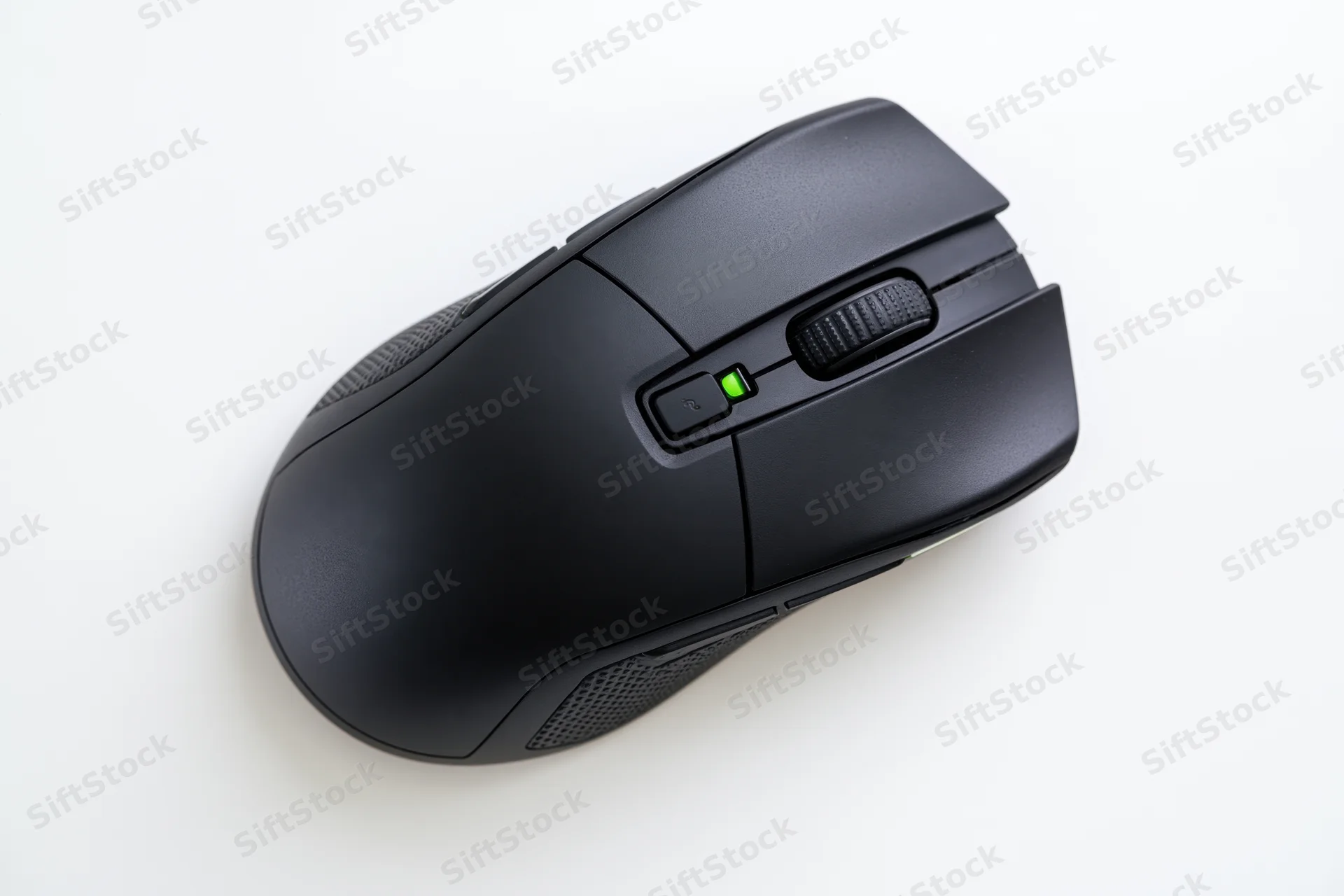 Black gaming computer mouse viewed from directly above on white surface