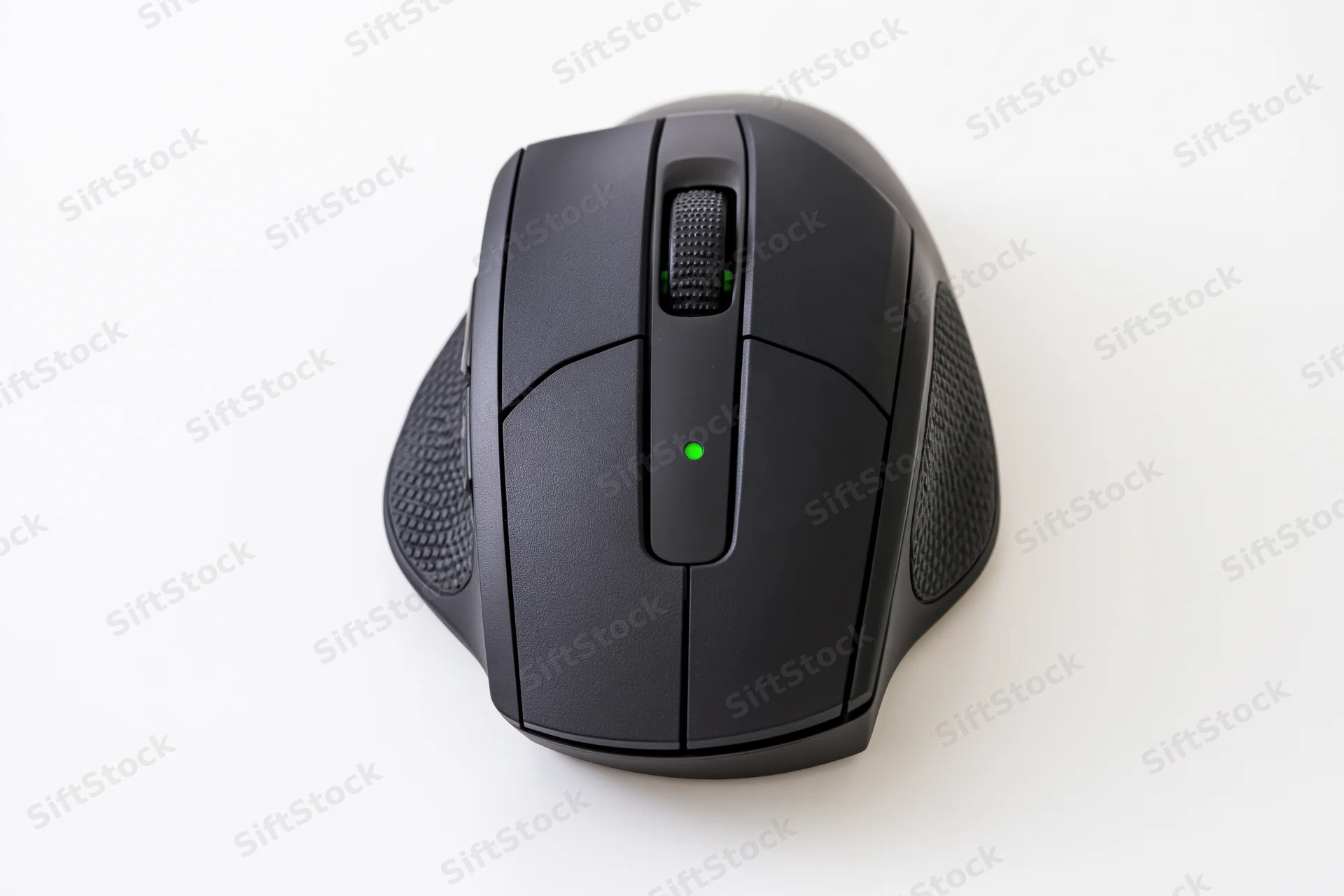 Black gaming computer mouse viewed from directly above on white surface