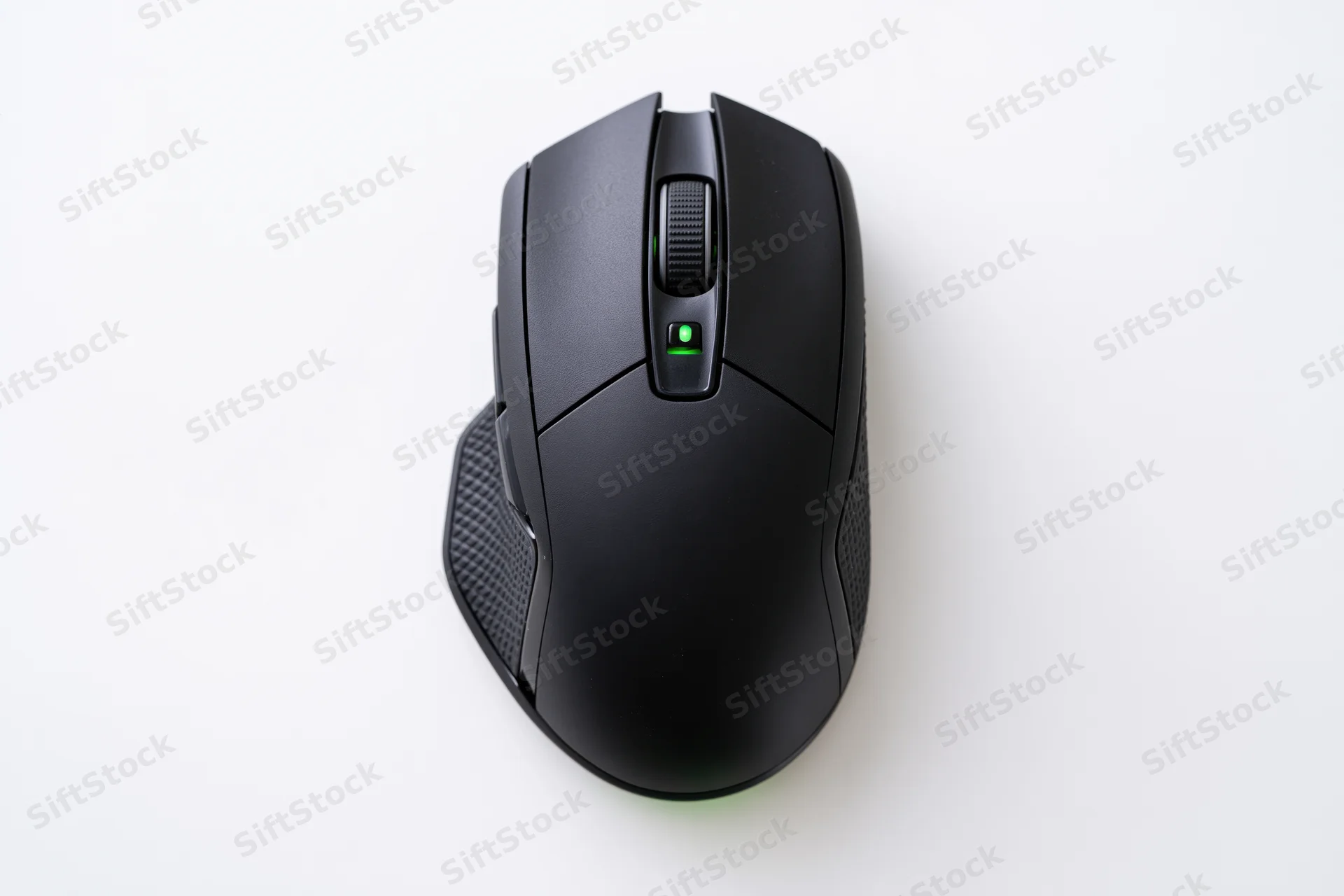 Black gaming computer mouse viewed from directly above on white surface