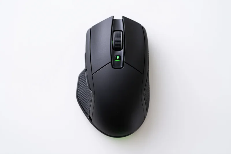 Black gaming computer mouse viewed from directly above on white surface